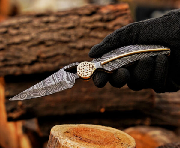 Handmade Damascus steel folding pocket knife held in hand, perfect gift for him and everyday carry.