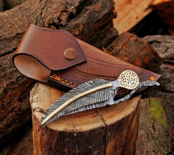 Back view of Damascus steel folding knife with feather handle and leather sheath, birthday gift for men.