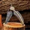Open Damascus steel folding pocket knife standing on wooden log, anniversary gift for husband.