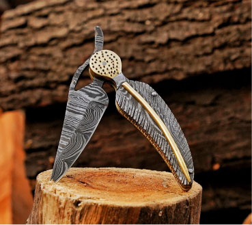 Open Damascus steel folding pocket knife standing on wooden log, anniversary gift for husband.