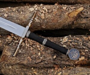 Handmade Witcher 3 inspired fantasy long sword with wall mount made from J2 steel displayed on wooden logs
