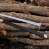 Handmade Witcher 3 fantasy long sword made from J2 steel displayed on wooden logs