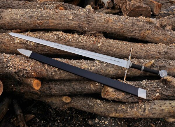 Handmade Witcher 3 fantasy long sword made from J2 steel displayed on wooden logs