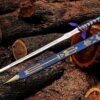 Handmade Zelda Master Sword replica with blue scabbard on wooden logs