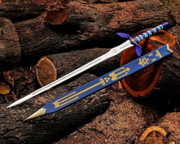 Handmade Zelda Master Sword replica with blue scabbard on wooden logs