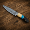Handmade Damascus knife with turquoise handle on rustic wooden background