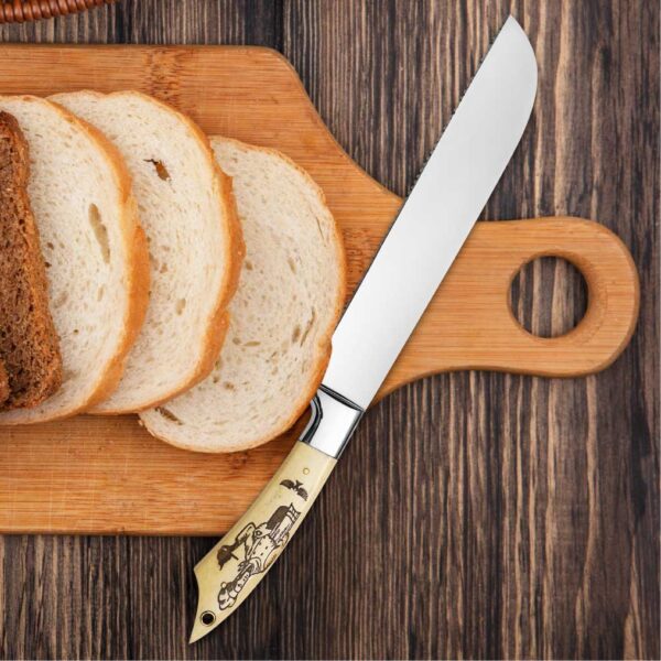 Handmade serrated bread knife slicing fresh bread on wooden cutting board.