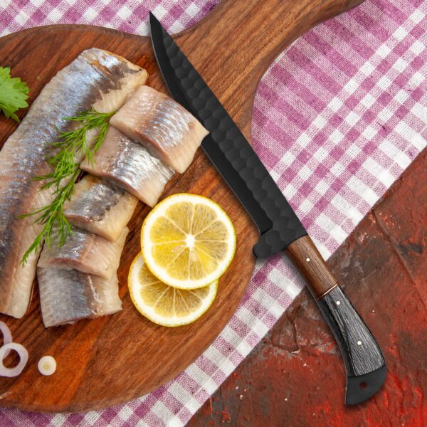 Handmade black forged slicing knife with fresh fish and lemons on a cutting board. Professional fillet knife, gift for him, chef, anniversary, Father's Day, Christmas, and wedding.