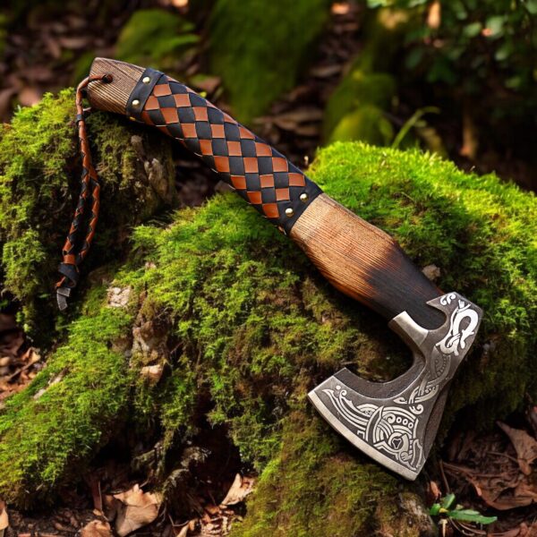 Rustic Viking hatchet with leather wrapped handle displayed outdoors