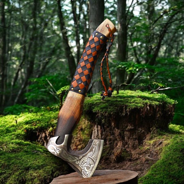 Handmade Viking axe standing in forest with engraved blade and leather grip