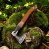 18 inch handmade Viking axe with leather wrapped handle displayed on mossy tree stump
