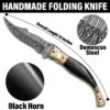 7.5-inch handmade Damascus folding knife with black horn handle and engraved brass bolsters.