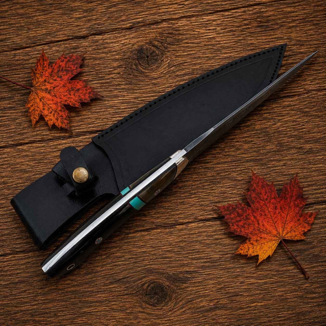 Handmade hunting knife with black genuine leather sheath displayed on rustic wood