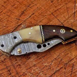 Close-up of Damascus folding knife showing camel bone and rosewood handle