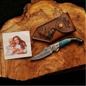 Personalized Damascus Pocket Knife with custom leather sheath and engraved artwork