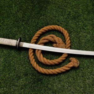 25 inch stainless steel decorative sword with white handle displayed on grass
