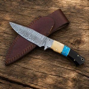 Home Handmade Damascus skinner knife displayed over a brown leather sheath