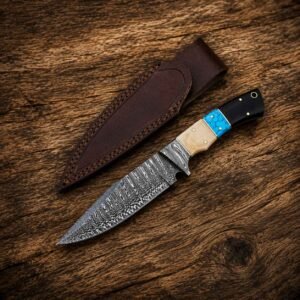 Handmade Damascus skinner knife with genuine leather sheath on wooden background
