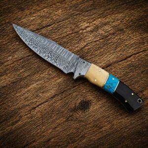 Home Handmade Damascus skinner knife with bone and turquoise handle displayed on a rustic wooden surface