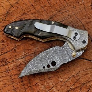 Open handmade Damascus folding knife with black handle