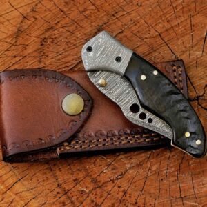 Folded Damascus pocket knife with black handle and leather sheath